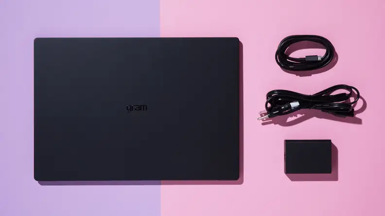 The LG gram Pro 17 laptop next to two USB cord and charging cube.