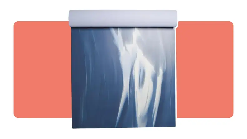 A blue and white lululemon yoga mat with an abstract print partially rolled up.
