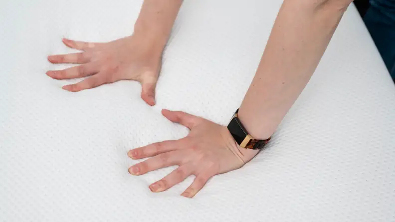 a woman presses her hands into the Purple