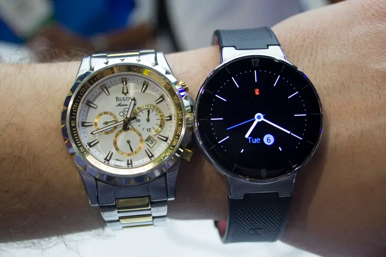 The OneTouch Watch next to an analog watch