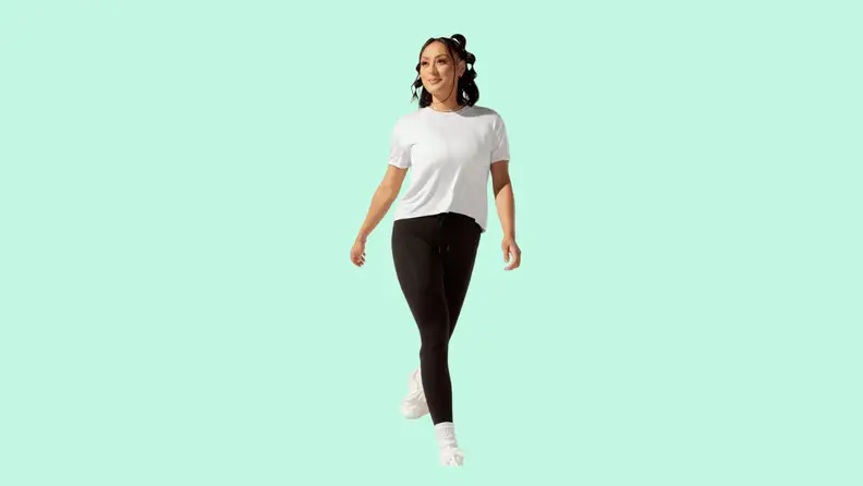 A model wearing black tights and a white T-shirt.
