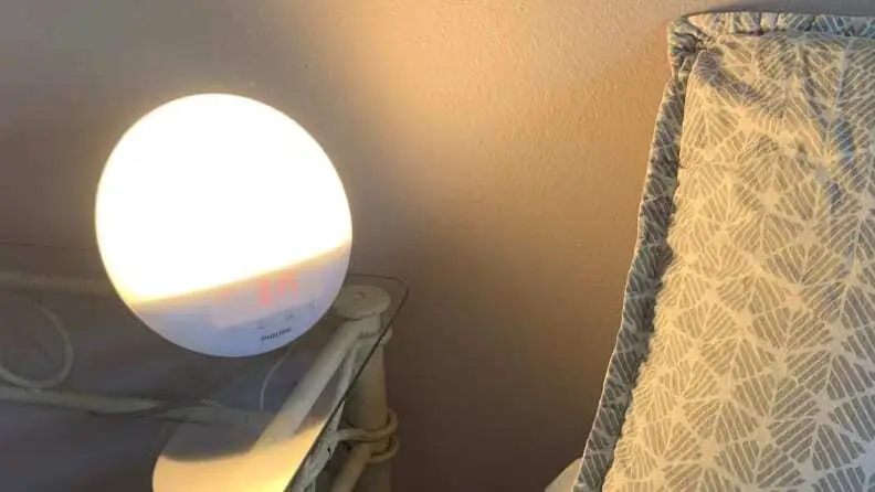 sunrise alarm clock on night table