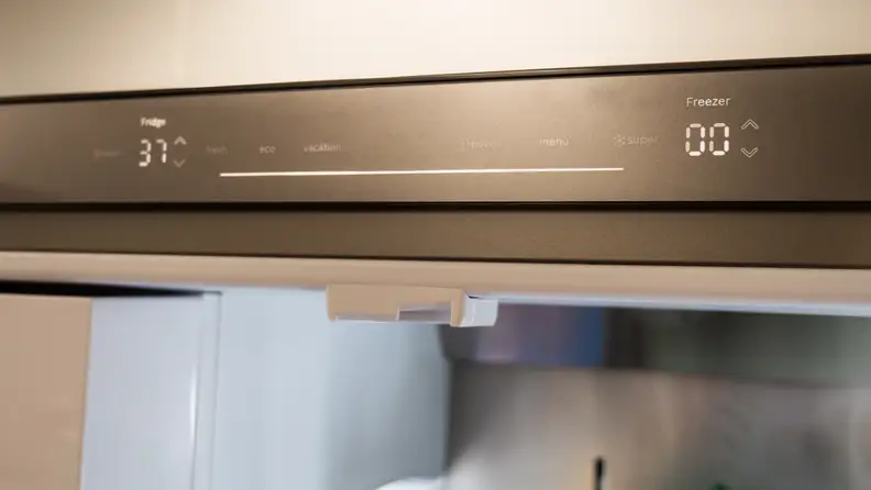 A close-up of the Bosch B36CD50SNS French-door fridge's touch button controls. They have a matte stainless steel look, and the LEDs underneath are seamlessly integrated.