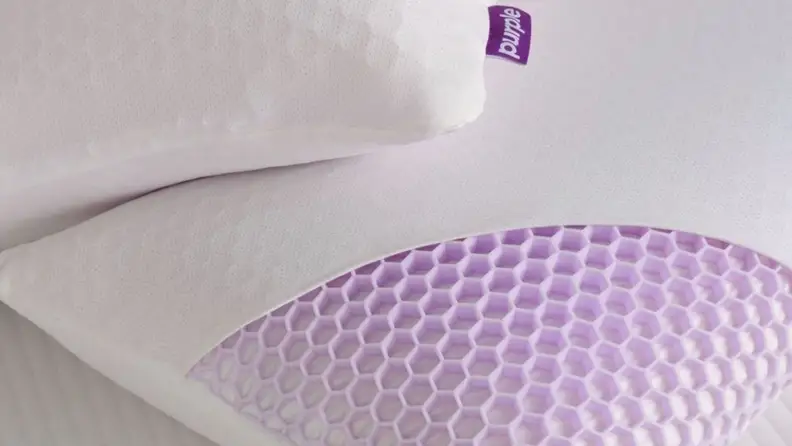 A picture showing the Purple Harmony pillow with the top layer of fabric removed to show the honeycomb grid
