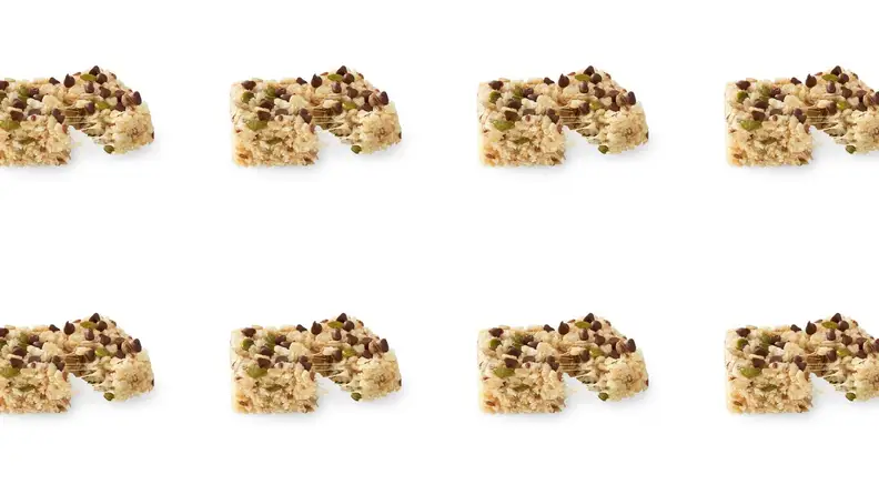 A repeating pattern of seed-filled chocolate chip rice crispy treats.