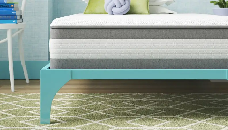 White and gray mattress on a teal blue bed frame