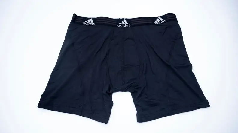 Black pair of Adidas Sport Performance boxer briefs with slight vignette effect lying on table.