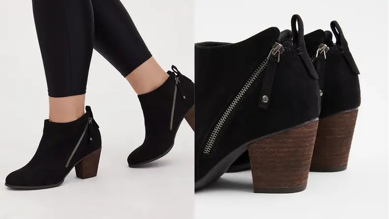 Feet wearing black booties and then closeup of the heel