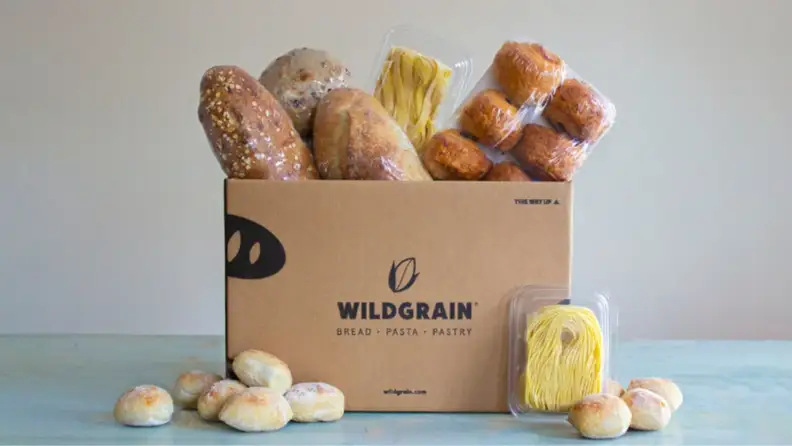 A Wildgrain box overflowing with bread, pasta, and pastries.