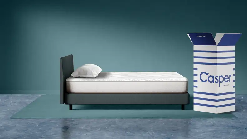 A side view of the Casper Snow mattress and the box it comes in.