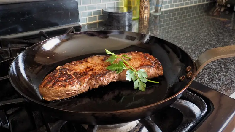 A steak searing in Mauviel carbon steel skillet.