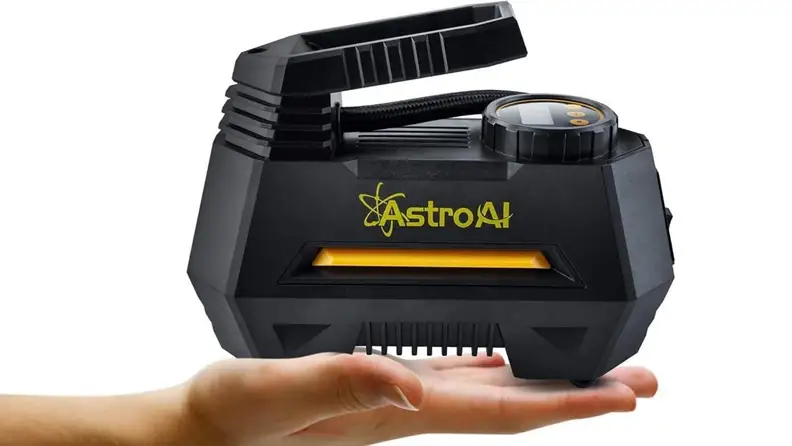 Compressor in person's hand against white background