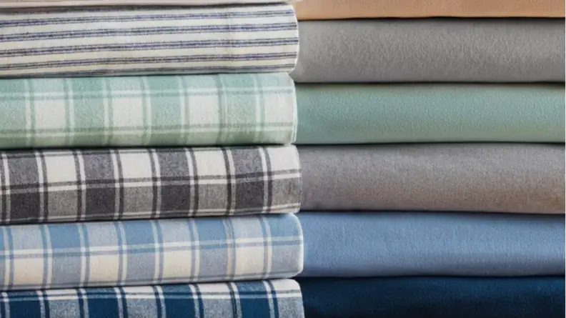 An image of stacked, folded topsheets in flannel.