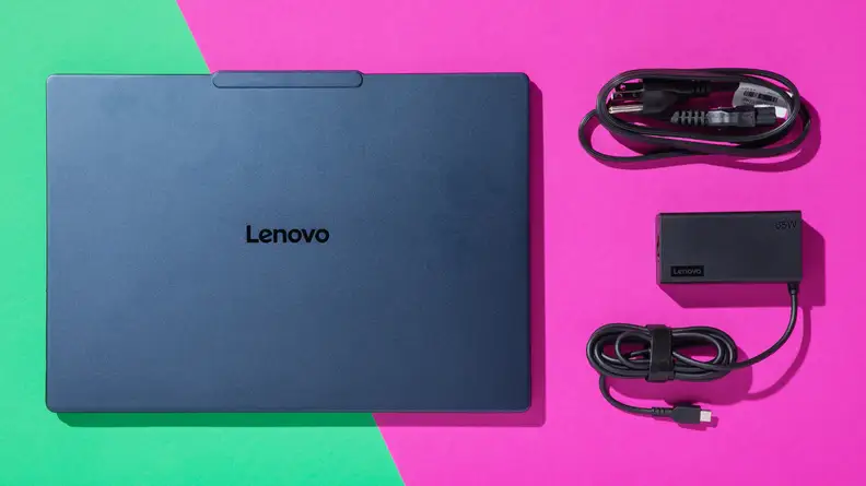 Lenovo Yoga Slim 7x next charge cord and USB cords on a teal and pink background.