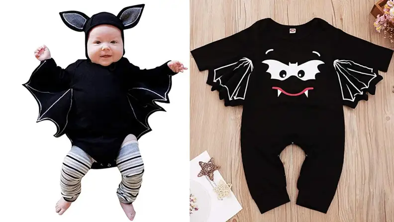 A baby dressed as a black bat for Halloween.