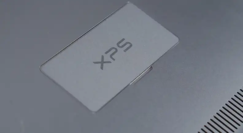 Dell hid the manufacturing symbols behind a thin metal flap, keeping the underside as minimalist as the top.