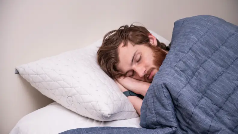 a man sleeps on the coop home goods pillow