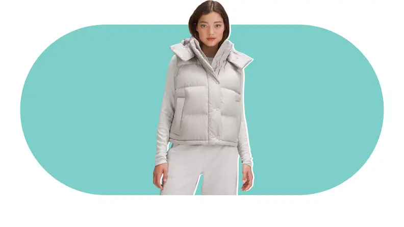 A model wearing a gray puffer vest.