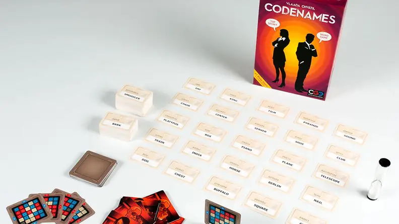 Codenames game laid out on white background