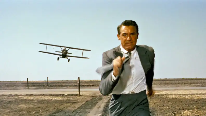 Cary Grant in "North by Northwest" (1959), one of the best thrillers to stream now, as he outruns a crop duster plane.