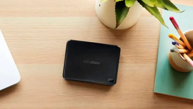Portable hard drive on wooden surface