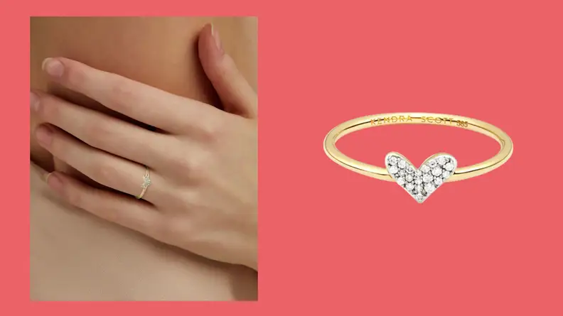 A delicate Kendra Scott gold ring in with small white diamonds in the heart shaped symbol.