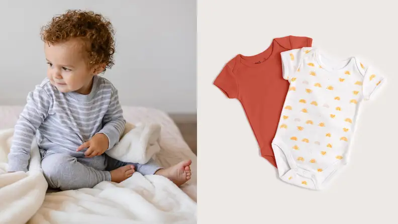 Left: baby Black boy looking to the right, wearing a blue striped onesie, on a bed. Right: two onesies on a blank background—a red onesie and a white one with red and orange designs