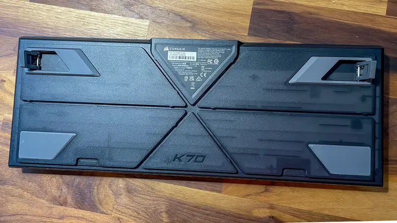 The back of a Corsair K70 Max RG keyboard with cable routing channels cut into it.