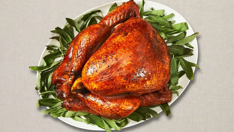 A Thanksgiving turkey on a bed of lettuce, shot from above.