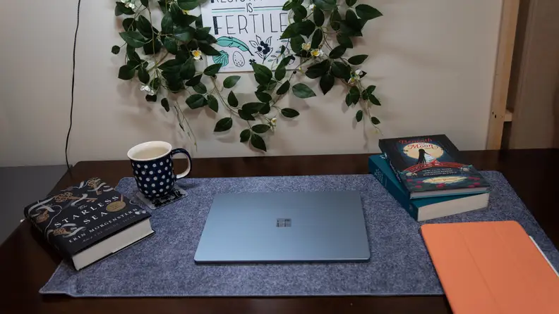 The laptop is closed on the desktop.