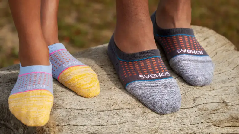 Two people wearing Bombas no-show socks