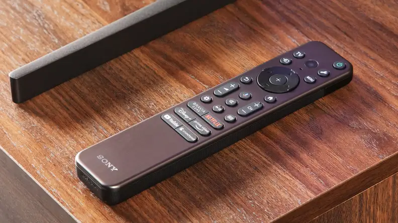 A close-up of Sony's latest remote control, placed on top of a wooden surface