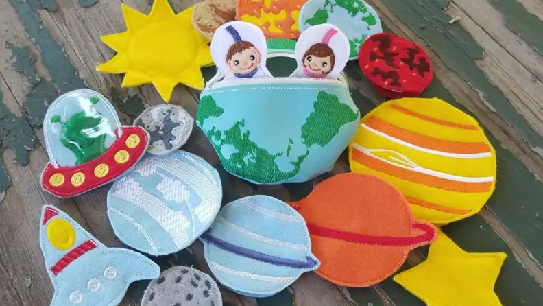 Set of cloth finger puppets that includes an Earth, a space ship and astronauts