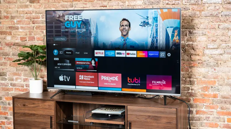 The Amazon Fire TV Omni displaying its smart platform's home screen in a living room setting