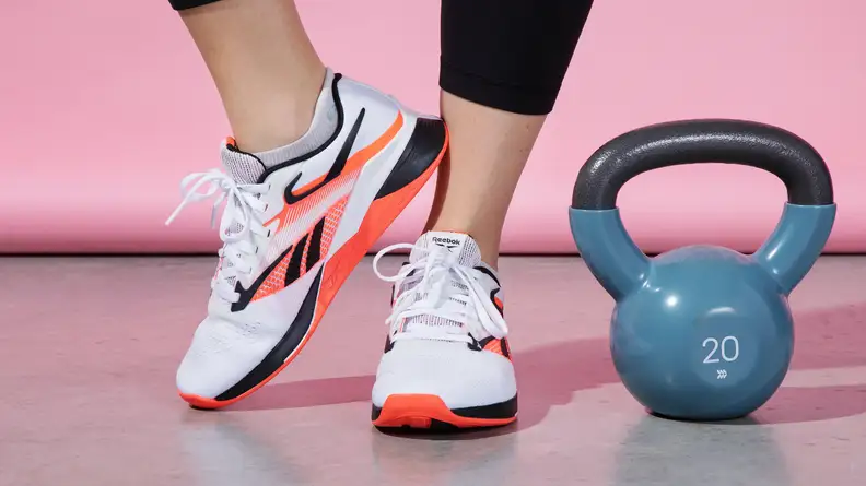 Nano X4's on feet with one foot up.