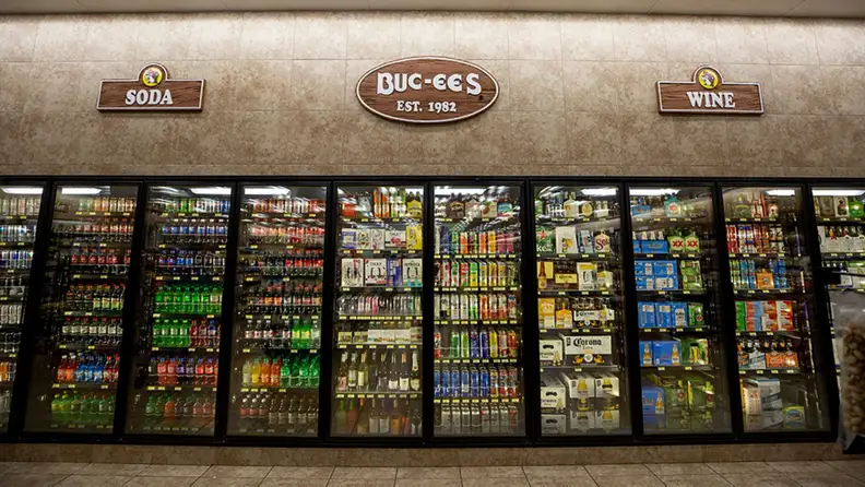 Rows of glass-door coolers stocked with soda, wine, and beer at Buc-ee's