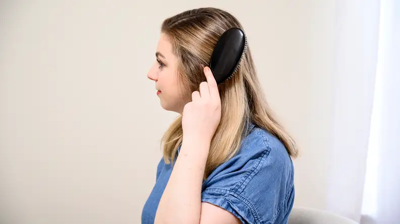 A photo of the author using the Mason Pearson hair brush.