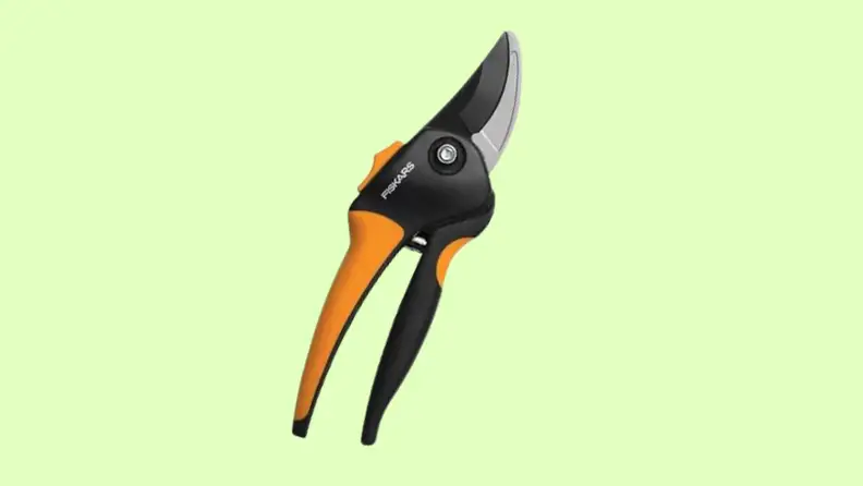 A pair of pruning shears on a green background