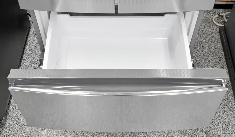 A close-up of the Haier HRF15N3AGS's upper freezer drawer .