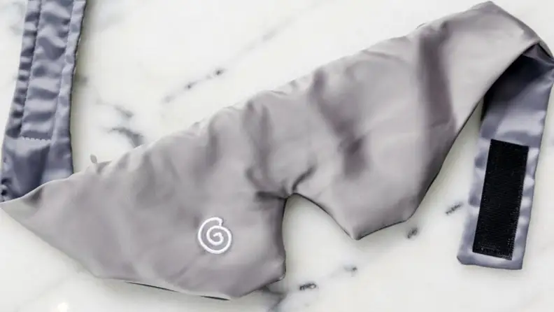 a gravity mask resting on white marble counter top