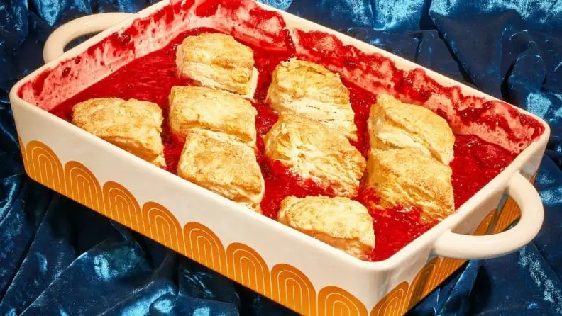 A sweet cobbler sits in a ceramic dish.