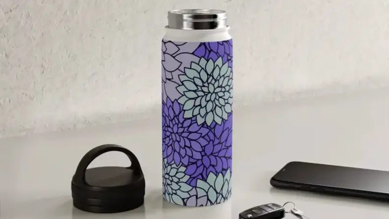 A purple water bottle on a kitchen counter.