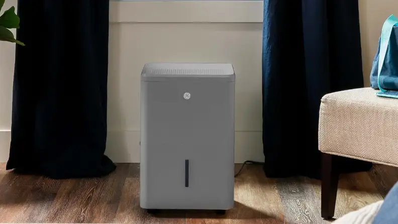 A grey ge dehumidifier sits on a floor