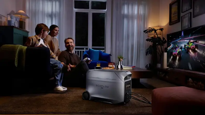 a family gathers around a TV, powered by an EcoFlow at home power supply, to play a video game at night