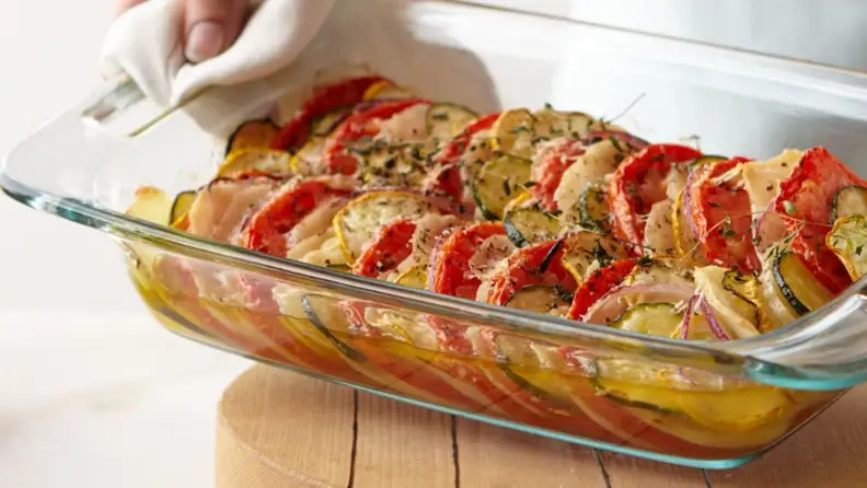 A Pyrex glass casserole dish filled with vegitables