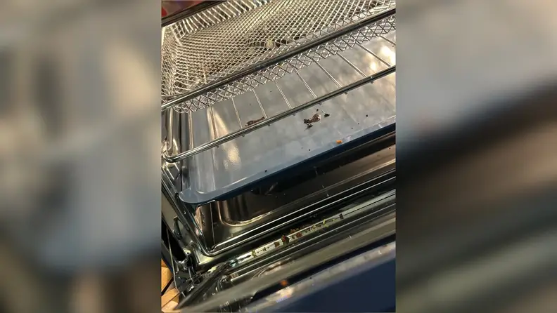 Interior of Our Place Wonder Oven Pro air fryer with metal racks.