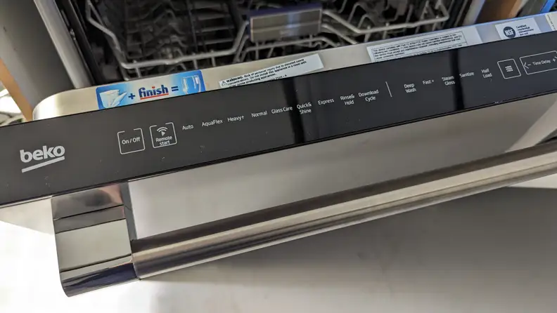 The control panel of a Beko dishwasher showing a rinse and hold cycle to keep dishes moist before washing