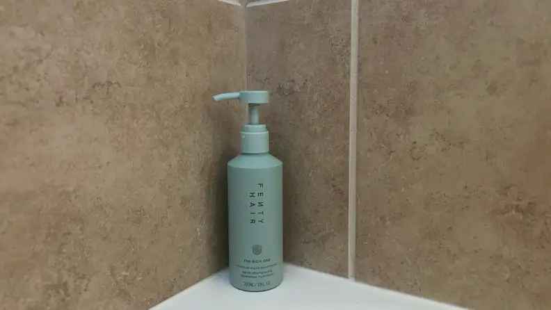 Photo of the Fenty Hair Rich One Moisture Repair Conditioner in a shower.