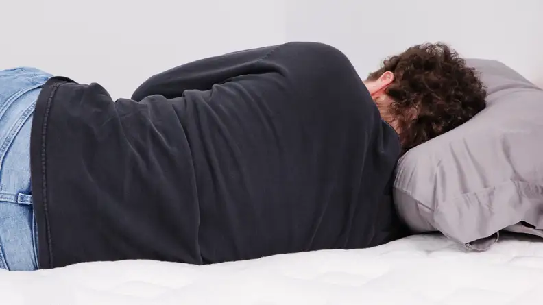 A person lying on their side on the Leesa Sapira Chill.