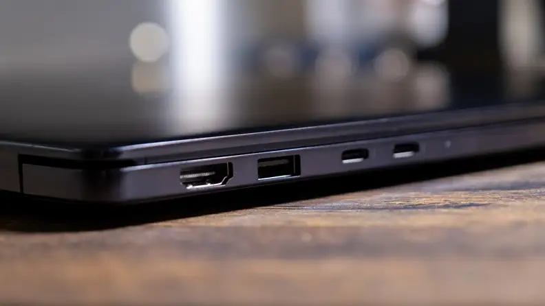 Side of Dell 14S (DS14260) laptop showing various ports for connectivity, on top of a wooden surface.
